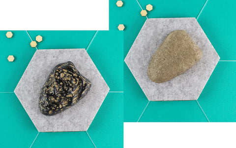 Rock key hider faux stone with hidden slot for spare keys in the garden or by the garage, brown and gray options on hexagonal tiles.
