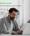 Man working on a laptop in a bright, quiet workspace