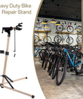 Ebike Repair Stand For Home Garage And Shop Use, Beefy Heavy Duty Bike Stand Holds Up To 110 Lbs, in a showroom setting with multiple bikes