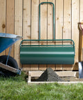 24 Inch Lawn Roller With 13 Gallon Capacity Heavy Duty Steel Yard Roller For Garden And Park Lawns against wooden fence