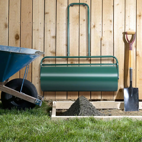 24 Inch Lawn Roller With 13 Gallon Capacity Heavy Duty Steel Yard Roller For Garden And Park Lawns against wooden fence
