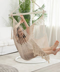 Cozy Cotton Rope Hammock Chair With 330Lb Weight Capacity, soft beige hanging swing in living room setting.
