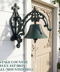 Badass Heavy Duty Cast Iron Outdoor Wall Bell With Slick Vintage Rustic Patina on a garden wall with a pull cord.