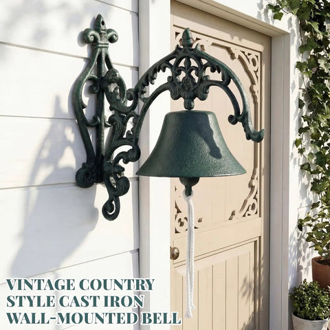 Badass Heavy Duty Cast Iron Outdoor Wall Bell With Slick Vintage Rustic Patina on a garden wall with a pull cord.