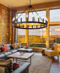 Black Wagon Wheel Chandelier 40 Inch With 20 Lights in cozy living room with high ceilings and vintage vibes.
