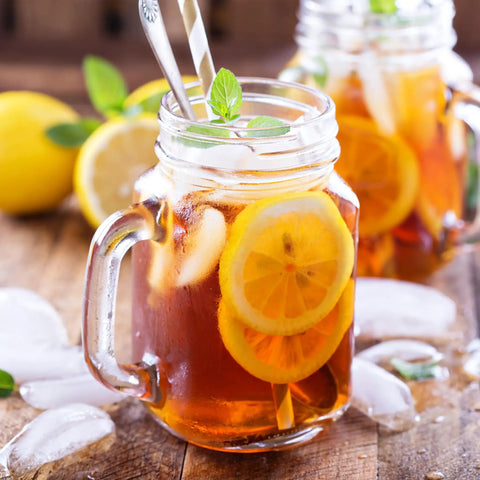 Generous 3 Quart White Stainless Steel Iced Tea And Cold Brew Coffee Brewing Pitcher With Adjustable Strength Dial and Removable Infuser Chamber, serving iced tea with lemon.