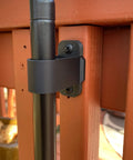 Keep It Clean Tiki Torch Deck Or Fence Mount For 0.75 Inch To 1 Inch Poles Keeps Torches Off The Deck Surface Safe For Kids And Pets Black Finish Patent Pending Vertical Design Fits Deck Posts Or Balusters 6 Sets Included Made In USA Weatherproof mounted on wood deck post.