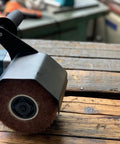 Heavy Duty Synthetic Fiber Abrasive Brush Drum For Grinding Machines Rust Removal Satin Finish On Unpainted Metals Flat Metal And Wood Surfaces Wire Drawing Attachment 120x100mm shown installed on a wooden surface