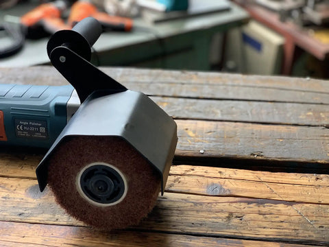 Heavy Duty Synthetic Fiber Abrasive Brush Drum For Grinding Machines Rust Removal Satin Finish On Unpainted Metals Flat Metal And Wood Surfaces Wire Drawing Attachment 120x100mm shown installed on a wooden surface