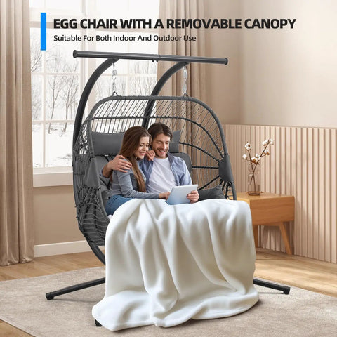 Double Egg Chair With Removable Adjustable Canopy For Outdoor Hangout Patio Balcony And Garden in indoor setting with couple
