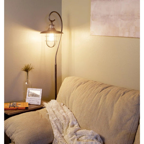 58 Inch Industrial Nautical Floor Lamp With Hanging Cage Shade, Brushed Pewter Finish in living room corner beside sofa