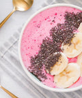 Smoothie bowl made with Organic Freeze Dried Strawberry Powder Bulk 20 Pound Bag Non GMO 100 Percent Pure No Additives Vegan topped with banana slices and chia seeds.