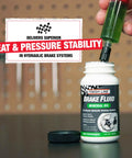 Person filling Bicycle Hydraulic Disc Brake Fluid Mineral Oil Low Viscosity For Crisp Lever Feel Smooth Pad Retraction And Consistent Stopping Power Long Lasting 16 Ounce Bottle