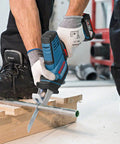 User operating Professional Grade Cordless Saber Saw on framing lumber and metal conduit for heavy duty renovations.