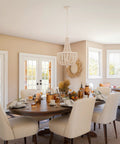 Dumas 3 Light Coastal Boho Chandelier With Weathered White Beads And Exposed Bulbs For A Cozy Vibe over dining area