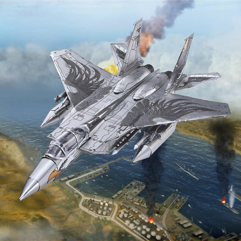 F-15 Fighter Jet Metal Model Kit for Adults, DIY 3D Puzzle to Build at Home flying over a detailed coastal scene.
