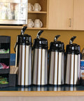 Four ECAL22S Eco Air Lever Airpot With Glass Vacuum Insulated Beverage Dispenser 2.2 Liter Thermal Coffee Carafes on counter
