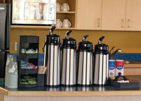 Four ECAL22S Eco Air Lever Airpot With Glass Vacuum Insulated Beverage Dispenser 2.2 Liter Thermal Coffee Carafes on counter