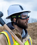 Construction worker wearing MX500 Safety Goggles With 23 Percent Gray Tint, Adjustable Cloth Strap, TruShield Anti Fog Coating