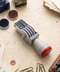 No Sweat 4 Digit Rubber Number Stamp With Adjustable Rotating Tapes For Office Inventory Warehouse Pricing Tags on a workspace.