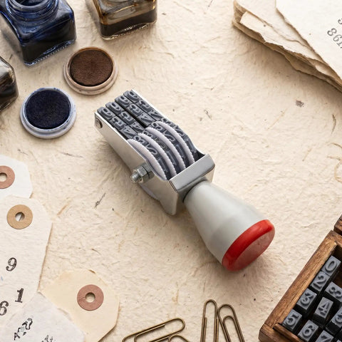 No Sweat 4 Digit Rubber Number Stamp With Adjustable Rotating Tapes For Office Inventory Warehouse Pricing Tags on a workspace.