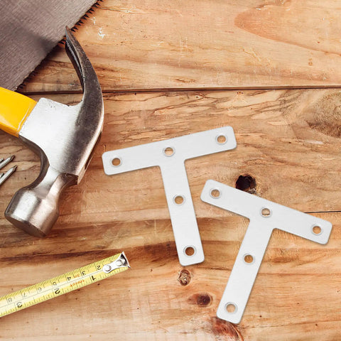 Beefy Heavy Duty Stainless Steel Corner Bracket Plates next to hammer on wood surface, ideal for shelving and panels, T shaped angle braces