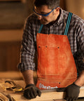 Man wearing leather welding apron 23x36 inches full split cowhide heavy duty work apron with 6 tool pockets in workshop