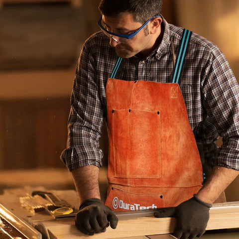 Man wearing leather welding apron 23x36 inches full split cowhide heavy duty work apron with 6 tool pockets in workshop