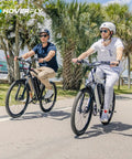 Two riders enjoying an OUREA 26 Electric Bike For Adults, 750W Peak Motor All Terrain Ebike, on a sunny path with palm trees.