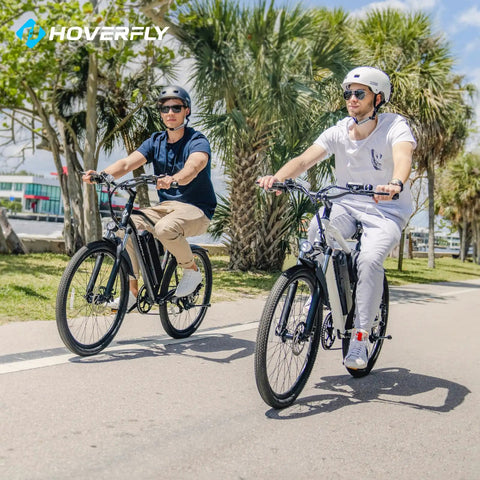 Two riders enjoying an OUREA 26 Electric Bike For Adults, 750W Peak Motor All Terrain Ebike, on a sunny path with palm trees.