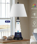 Table lamp with lighthouse design, white shade, 26 in. tall on wooden table near window. 800 lumens, rotary switch, 6W LED