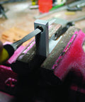 Swiss Pattern Needle File Set with handle being used on metal held in vise, close-up of tool and precision work