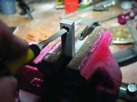 Swiss Pattern Needle File Set with handle being used on metal held in vise, close-up of tool and precision work