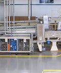 Industrial equipment with pipes and machinery in a factory setting.