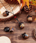 Five Pack Rainbow Wood Acorn Pendant Set With Openable Mini Cremation Urns For Ashes on wooden table