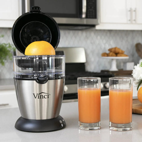 Compact Automatic Citrus Juicer With Hands Free Electric Press For Fresh Orange Lemon Lime Extract in a kitchen setting.