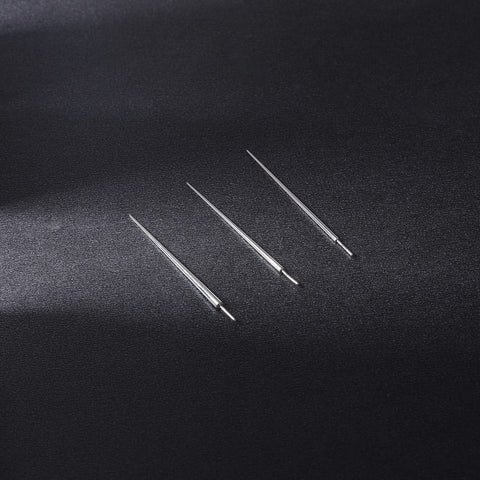 Three Two Piece G23 Titanium Insertion Pin Tapers for Nose Ear Navel Lip Piercings Kit 18G to 14G on black surface