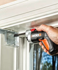 4V XTD Xtended Reach Cordless Screwdriver Pro Grade With Extending Shaft used to fasten a bracket on a white door frame
