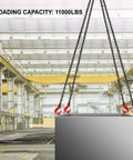 Four-leg chain sling with red grab hooks lifting a large gray metal crate in an industrial warehouse.