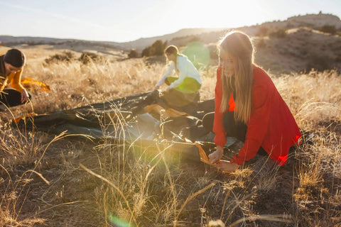 Campers setting up the Grand Mesa 2 Footprint for Tent Lightweight Water Resistant Ground Cloth Built for Grand Mesa 2 Person Tent