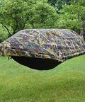 All In One Camping Hammock Tent With Mosquito Net And Rain Fly 3 In 1 Outdoor Hammock set up in a leafy backyard