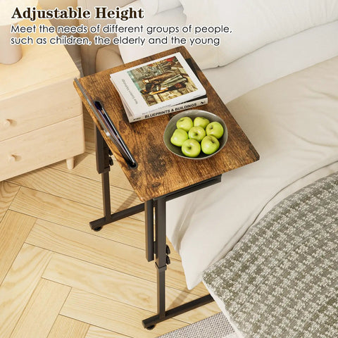 Adjustable Folding TV Tray Table For Eating And Snacking next to bed with book and fruit, brown MDF top, 6 height levels, C shaped legs