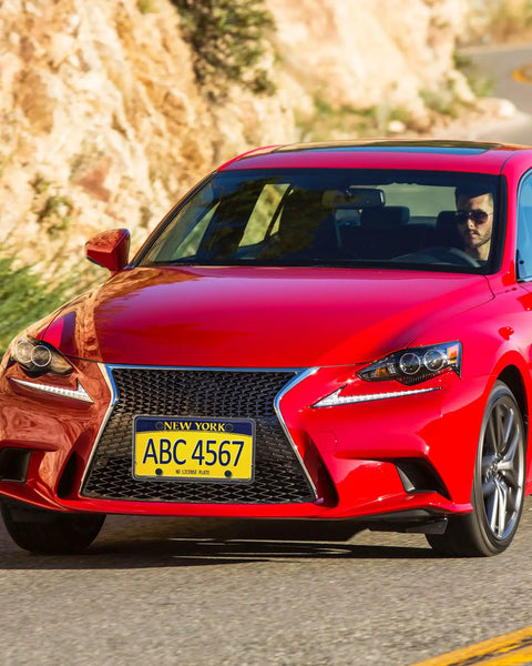 Red car with Front License Plate Holder Bracket Universal Plastic Front Car Tag Mounting Frame driving on winding road