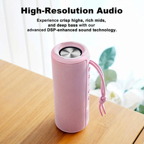 Outdoor Portable Bluetooth Boombox Speaker Waterproof, True 16W Power Sound with 100 Ft Bluetooth range, pink design on table.