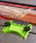 Bow FeatherPRO FP1 featherboard with green base and black knobs on a table saw, wood strip nearby