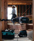 Rock Solid Eighteen Volt Cordless Hammer Driver Drill Kit Featuring Killer Torque Two Speed Gears and Hella Durable Ergonomic Build in use drilling wood.