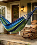 Portable Hammock With Storage Bag And Straps For Indoor Outdoor Relaxation And Camping Great For Patio Porch Backyard And Easy Tree Hammock Setup Blue on porch with rocking chair.