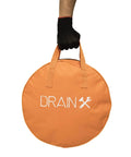 Easy Twist Drain Auger For Clogs Flexible 50 Ft Cable Half Inch Diameter Plumbing Tool Kit storage bag with black glove holding it