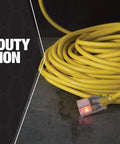 Coiled yellow All Purpose Outdoor Extension Cord With A Lit End 50 Feet 12 Gauge 3 Prong SJTW Vinyl Jacket on concrete.