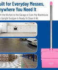 Straight Up Heavy Duty Standing Floor Dustpan With Thirty Inch Aluminum Handle And Serrated Comb Edge For Total No Sweat Commercial Cleanup And Daily Facility Sweeping Pink positioned in a kitchen, garage, and warehouse.